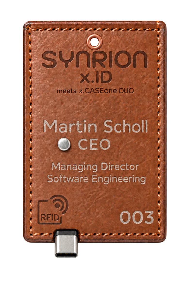 Vernähte Lederfassung mit individueller Beschriftung, RFID-Symbol, kupferfarbener Öse und USB-C-Anschluss.